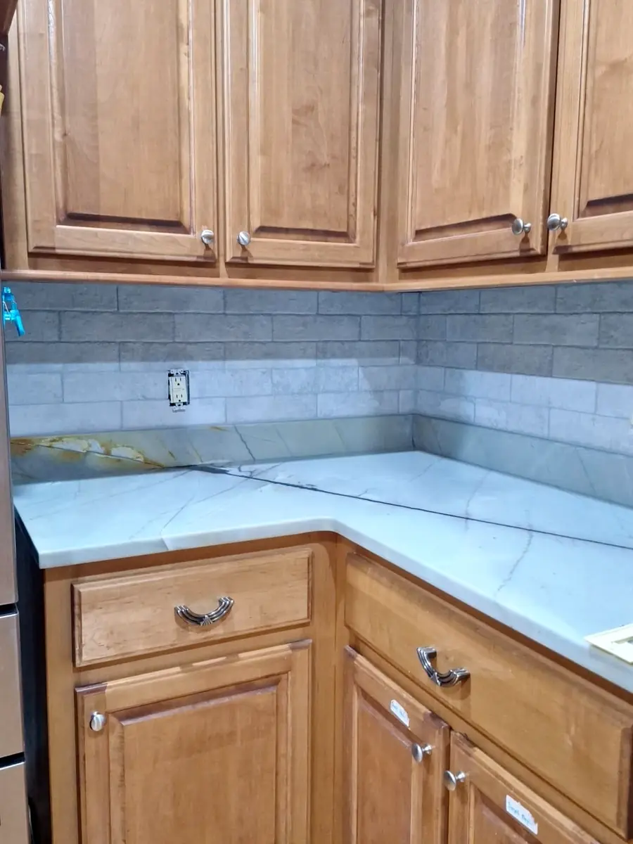 Kitchen backsplash in grey subway tile with new countertops